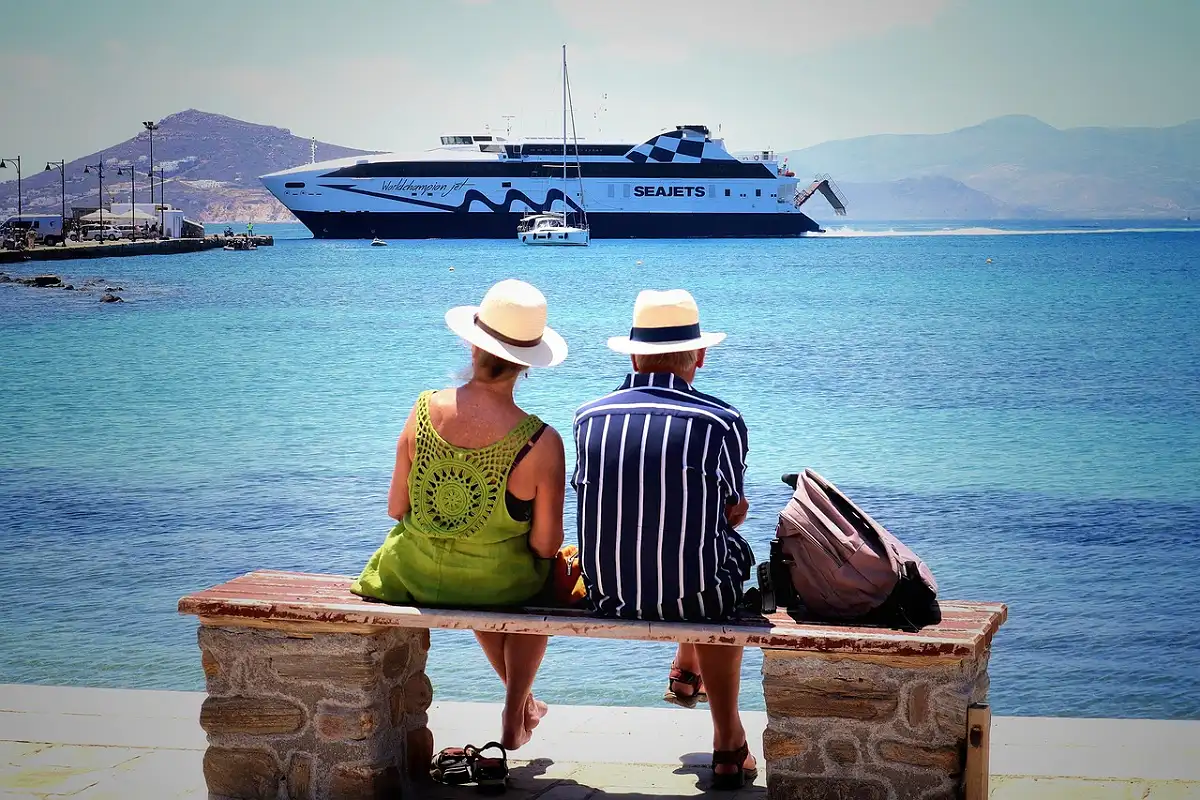Travelers waiting at a Cycladic port as the ferry arrives