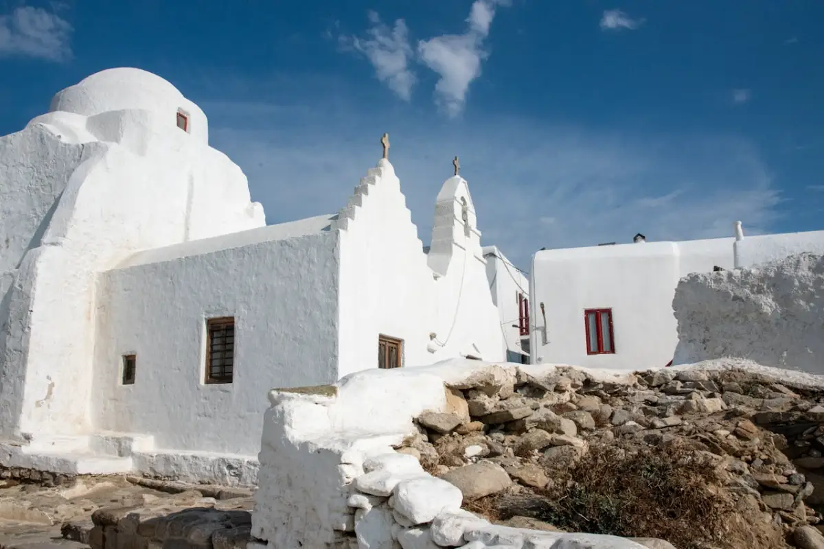 Traditional whitewashed church in Mykonos, Cycladic architecture under blue sky